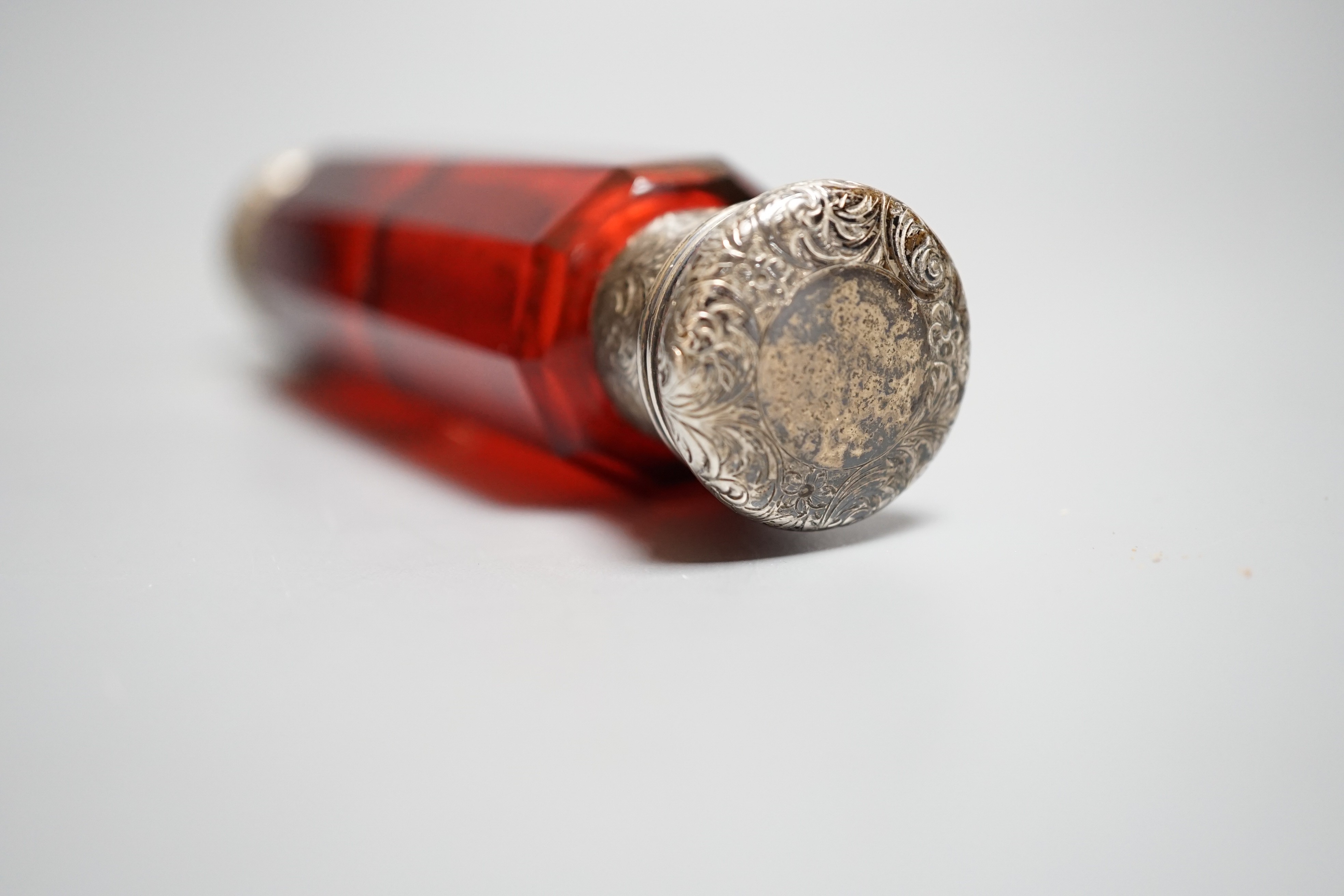 A Victorian engraved white metal and ruby glass double ended scent bottle, 12.7cm.